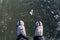 In winter Concept Man wear hiking boots standing on a frozen ice rive covered snow