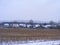 Winter country view. Festive background. Agriculture farm field view. Winter snow nature landscape. Cozy scene. Cold season
