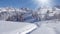 Winter countryside with mountains, fir trees and snowfall.