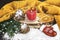 Winter cozy still life with red burning candle, Christmas tree toy glove, snowy cones, dried oranges, yellow scarf