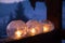 Winter craft: Ice lanterns with flickering fire of a candle