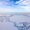 Winter day above frozen tundra lakes, top view