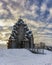 Winter day in the forest Park. Wooden Pokrovsky Cathedral, a monument of wooden architecture