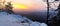 Winter daybreak in sandstone rocks of Bohemian-Saxon Switzerland park. View from the rock peak over valley.