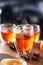 Winter drinks Hot Aperol Spritz three glass cups on a bar counter