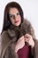 Winter Elegance: Fashion Studio Portrait of a Beautiful Woman in a Brown Fur Coat