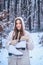 Winter emotion. Outdoor portrait of young pretty beautiful woman in cold sunny winter weather in park. Portrait of a