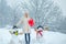 Winter emotion. Winter clothes for woman. Happy girl playing with a snowman on a snowy winter walk. Winter morning.