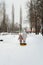 Winter entertainment and leisure in Russia. Mom walks with her daughter and snow tubing along the paths in the park