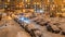 Winter evening courtyard in a residential complex covered with snow and cars