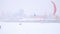Winter extremal sport - a lot of snow-kite sportsmen`s rides on the ice river at blizzard cloudy day