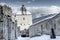 Winter fairy tale castle under snow with mountains in background