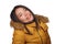 Winter fashion isolated portrait of young beautiful and happy Asian Korean woman in warm yellow feather jacket with fur hood