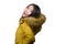 Winter fashion isolated portrait of young beautiful and happy Asian Korean woman in warm yellow feather jacket with fur hood