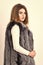 Winter fashionable wardrobe for female. Silver fur vest fashion clothing. Boutiques selling fur. Woman makeup face wear