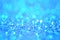 Winter festive shine sparkle glitter macro concept in blue color. Bokeh defocus disco effect.