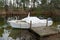 Winter fibre glass cruise boat with white tarpaulin cover steering wheel and outboard dashboard seat in lake lacanau river