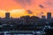 Winter fiery dawn over the city. Panoramic view of a modern residential area and a delightful sky in the background.