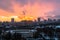 Winter fiery dawn over the city. Panoramic view of a modern residential area and a delightful sky in the background.