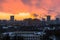 Winter fiery dawn over the city. Panoramic view of a modern residential area and a delightful sky in the background.