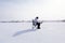 Winter fisherman on frozen lake