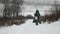 Winter fishing. Adult fisherman with professional fishing equipment and rod is going on frozen lake to catch fish