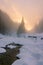 Winter foggy sunset on ice mountains river