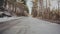 Winter forest asphalt snowy road flying camera sunny day mountain empty woods flares hike