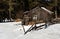 Winter forest scene. Small cottage along a tree line in a sunny winter day. Snowy fairytale in Bulgaria.