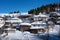 Winter forest scene. Small houseÑ at the mountain in a sunny winter day. Snowy fairytale in Bulgaria.