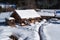 Winter forest scene. Small house at the mountain in a sunny winter day. Snowy fairytale in Bulgaria.