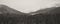 Winter forest in snow. Mountain landscape with a footpath. Sunny day and frosty weather