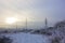 Winter. Frosty landscape. Transmission tower or electricity pylon to support an overhead power line. Russia