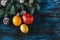 Winter fruits, orange, pomegranate, lemon on a blue wooden background