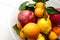 winter fruits stand together in a bowl,a person holds an quince,close-up quince fruit