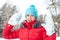 Winter fun- young cheerful teenage girl showing snowy gloves