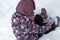 Winter, games, family, childhood concepts - authentic little preschool minor girl in pink hat warm clothes have fun