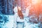 Winter girl having fun in winter park. Global cooling. Winter portrait of young woman in the winter snowy scenery.
