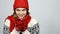 Winter girl in red warm knitted hat and scarf holding cup of tea