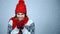 Winter girl in red warm knitted hat and scarf holding cup of tea