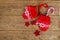 Winter gloves with candy cane on wooden table