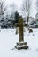 Winter graveyard cross at a war cemetery covered with fresh snow