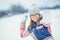 Winter happy teen girl playing in snow throwing snowball