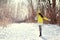 Winter happy woman walking in snow outdoors nature