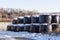 Winter hay bales in snow on a farm