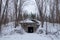 Winter. Hidden in the forest entrance to the secret soviet military bunker, echo of cold war