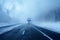 A winter highway, snowfall, and fog create poor visibility conditions