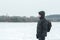 Winter hiker looking at snowy plain forest amazing landscape