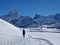 A winter hiker walking on a groomed trail near Bachalpsee with view towards schreckhorn