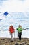 Winter hikers walking on ice glacier in Iceland. Tourists hiking in mountains in cold weather with hiking poles and
